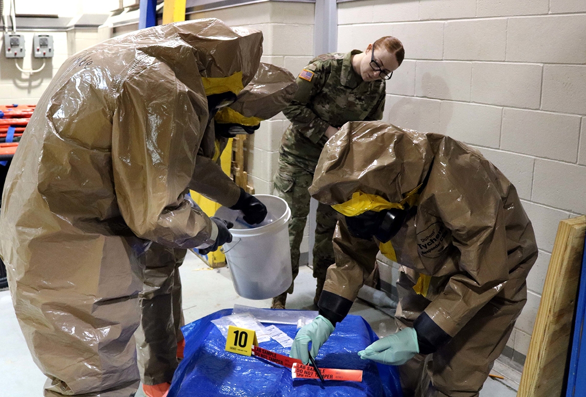 Soldiers wearing DuPont Tychem Responder CSM chemical suits while training on sampling threats.