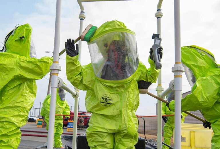 Soldiers wearing DuPont Tychem 1000 suit being decontaminated after training.