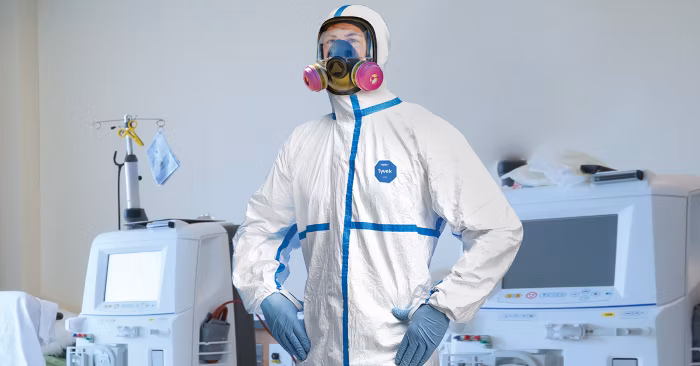 A man wearing Tyvek 600 coveralls for protection in pharmaceutical manufacturing, medical applications, research and biosecurity laboratories, nuclear and maintenance