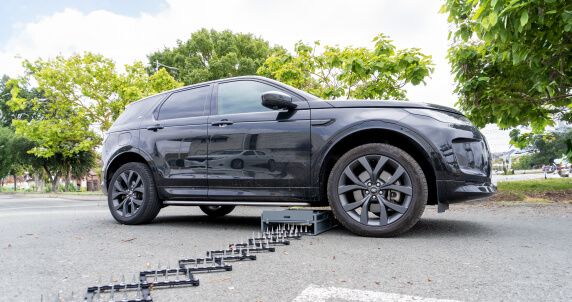 Shark Spike underneath car and deployed for oncoming vehicles