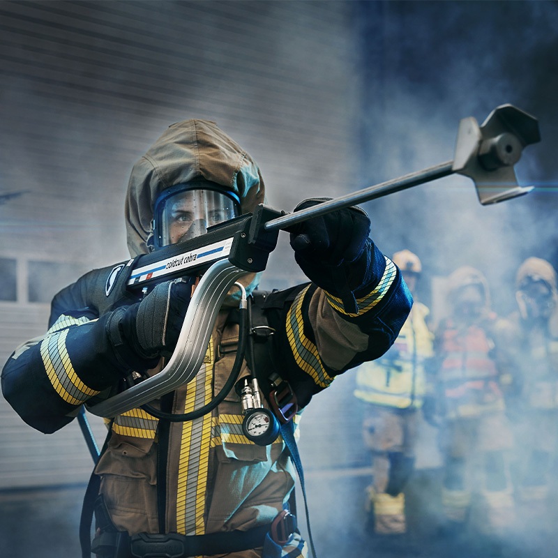 fire fighter holding up cold cut cobra extinguisher