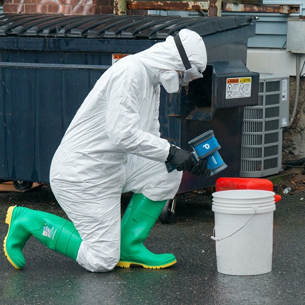 Individual in hazmat gear using Pendar X10 Handheld Raman Spectrometer