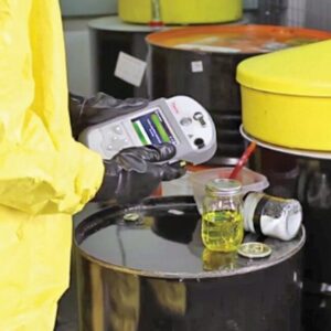First Responder in a hazmat suit using the Gemini handheld chemical anlyzer to identify unknown chemicals