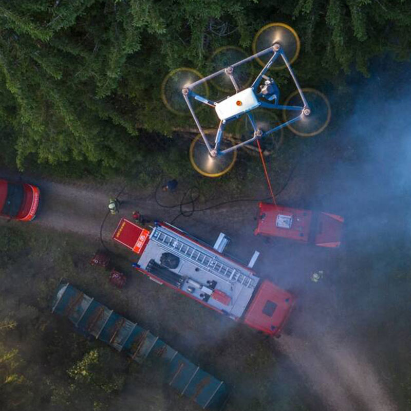 Drone flying over an accident while first responders survey the area.