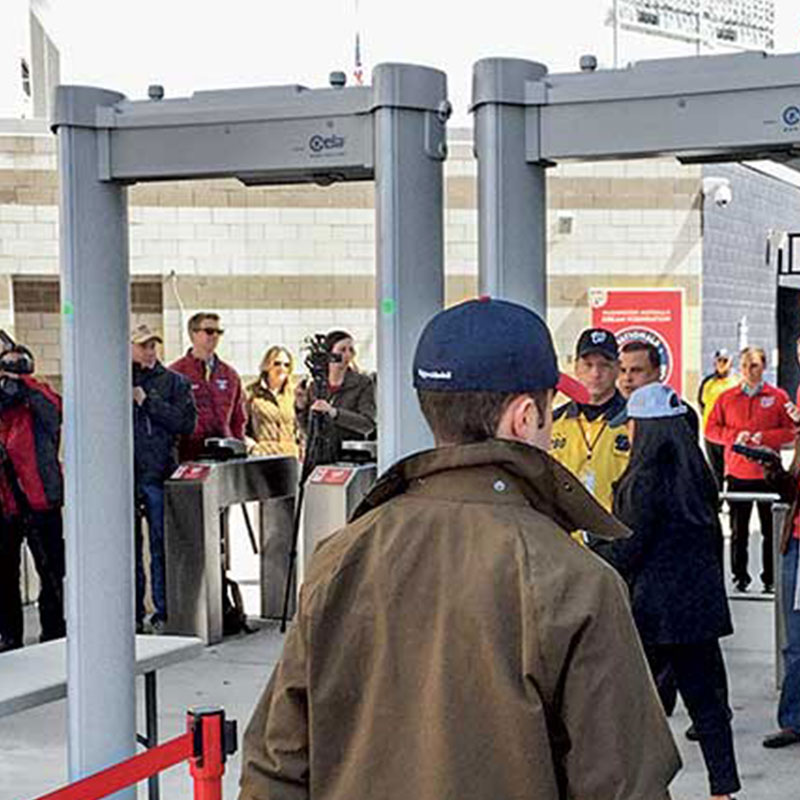 Person walking through a CEIA Metal Detector at an event at a stadium