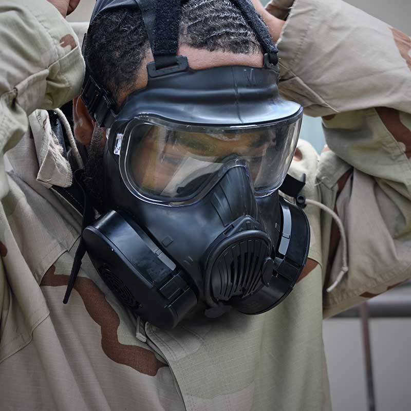 Solider training on how to properly wear a CBRN respiratory mask
