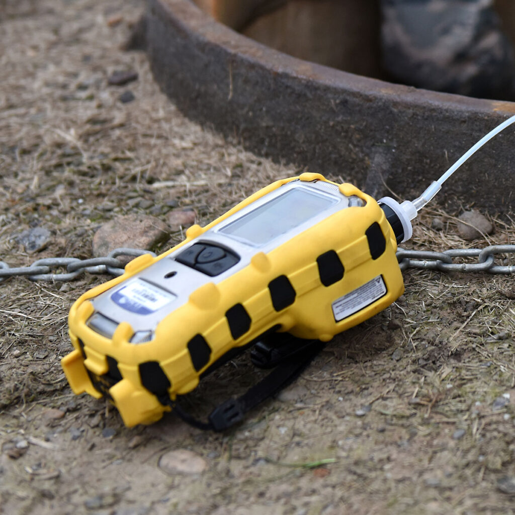 Honeywell RAE Systems MultiRAE Pro lying on ground and in use right beside a manhole