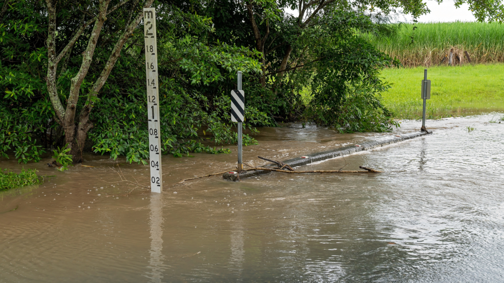 Flooeded roadway with flood depth marker