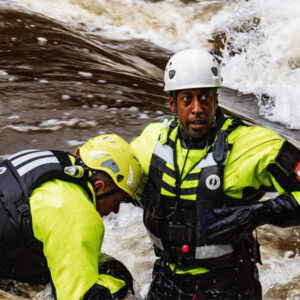 Mustang Survival gear worn by rescue worker in fast moving water