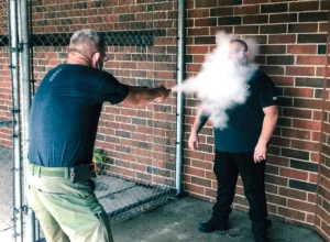 Pepperball BLAST Handheld Launcher INERT Loaded Cartridge tested on volunteer officer
