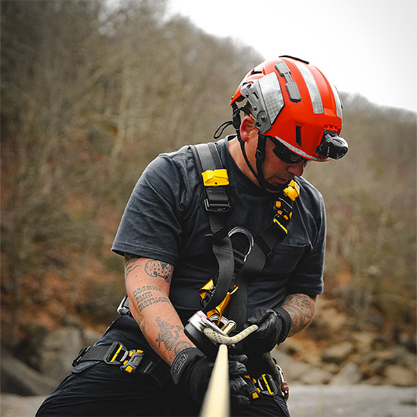 Team Wendy SAR Tactical Helmet Orange worn by man rappelling down rope