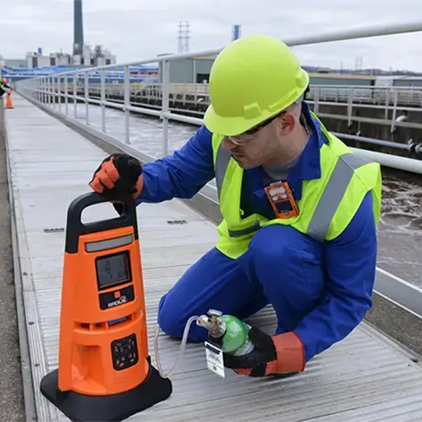 Industrial Scientific Radius BZ1 Area Monitor on sidewalk set up by worker