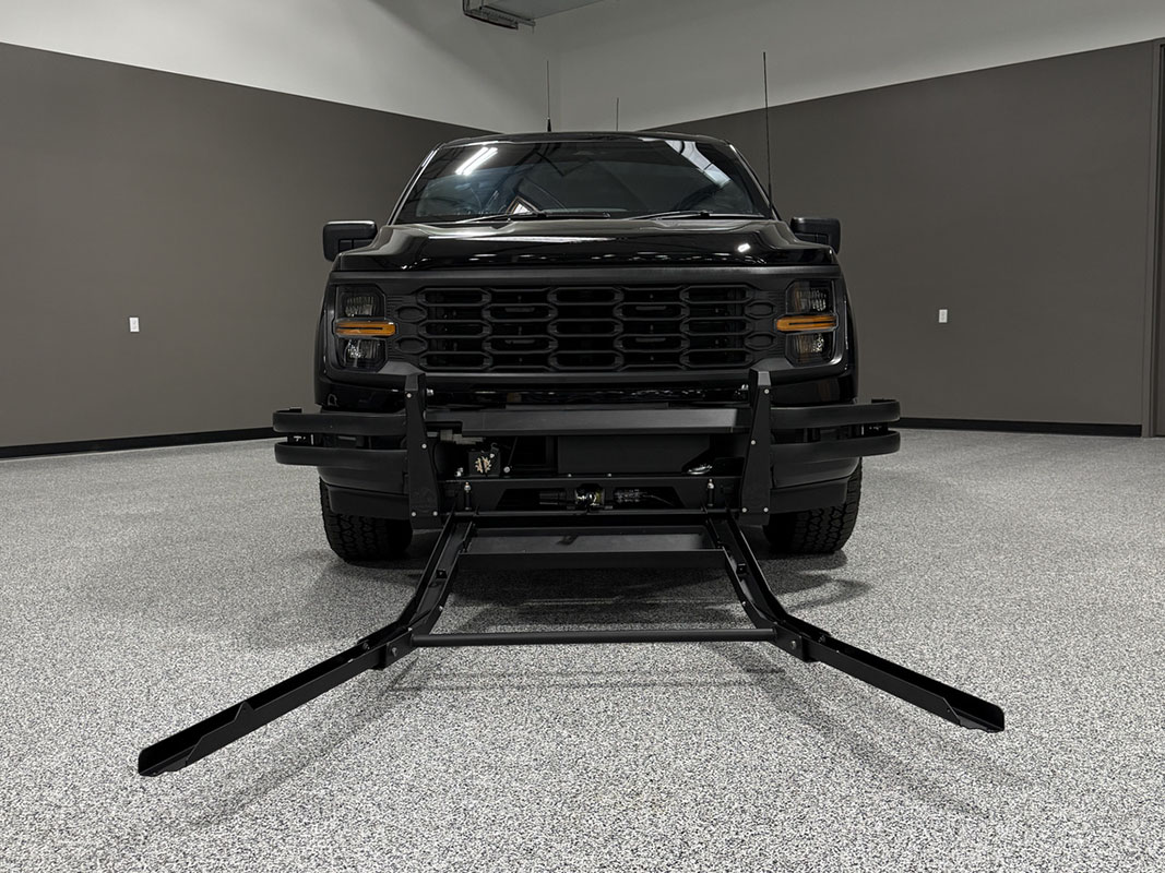 ADS Talon Pursuit Mitigation Device installed on the front of a police SUV in down position and no net shown.