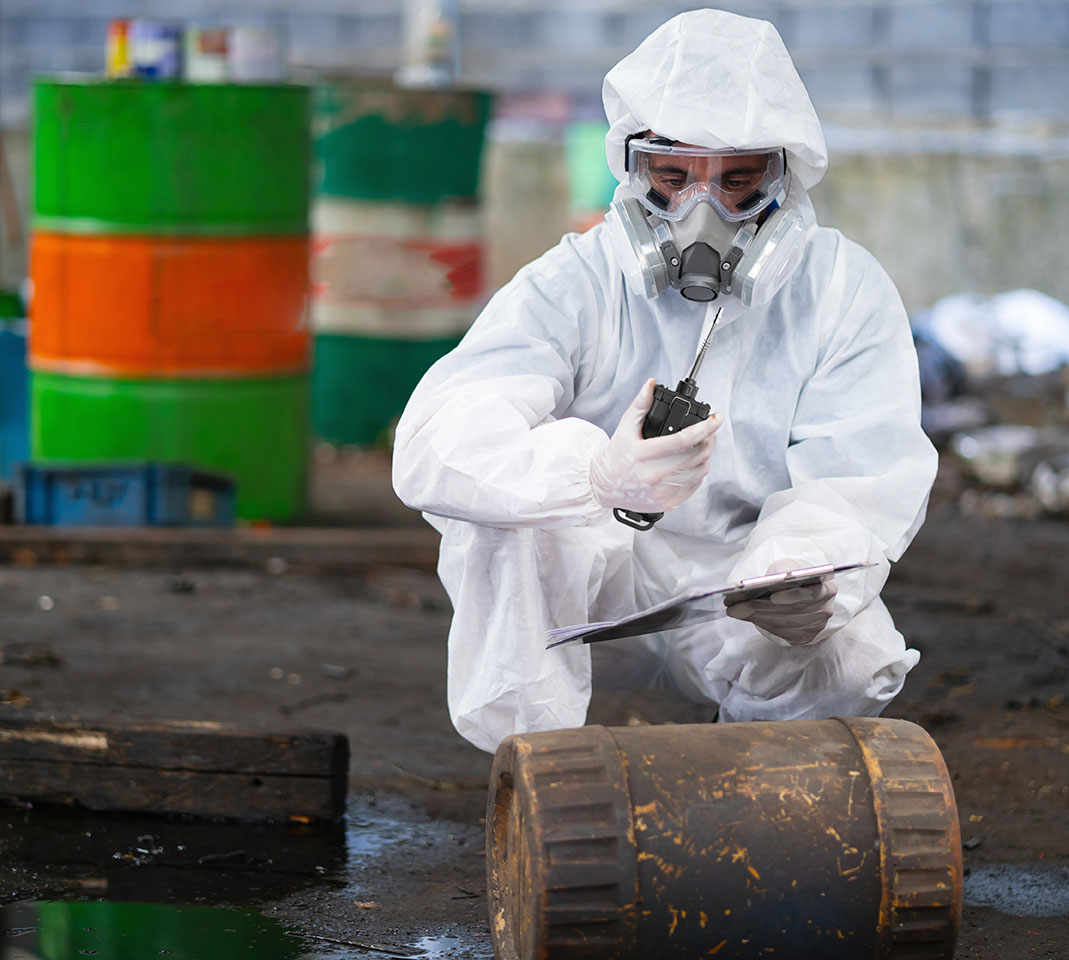 Honeywell ModRAE Portable Gas Detector being used by a hazmat responder in a white chemical suit